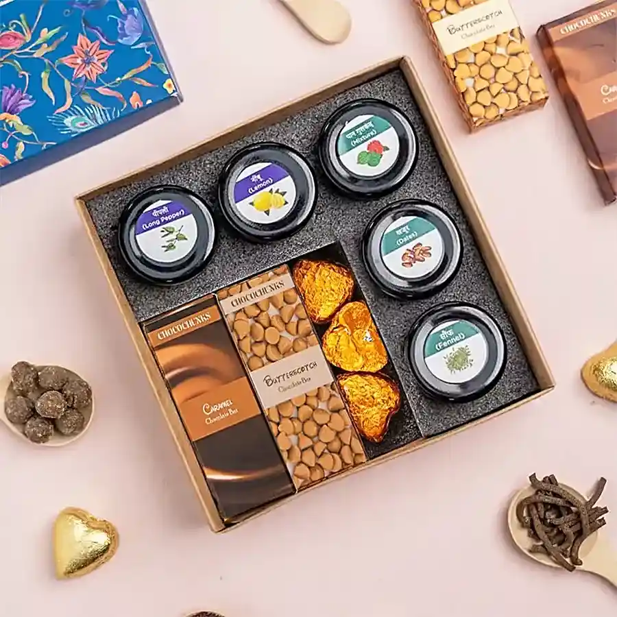 Indulgent Assorted Mukhwas and Chocolates Treat Box featuring five flavors of mukhwas, butterscotch and caramel chocolate bars, and heart-shaped chocolates.