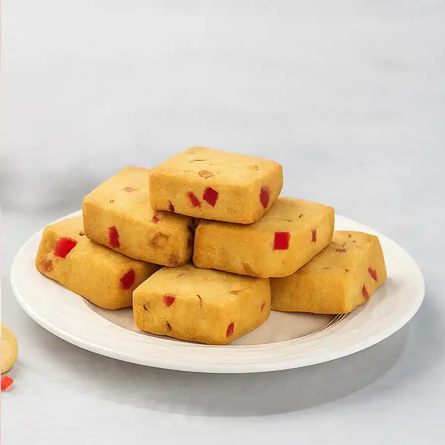 A box of Karachi Cookies surrounded by festive decorations, showcasing the delicious, crispy cookies inside.