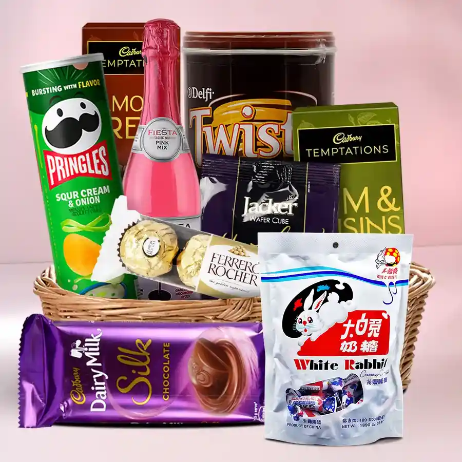 Mouthwatering Christmas Hamper filled with festive treats including chocolates, chips, candies, and juice arranged in a decorative basket