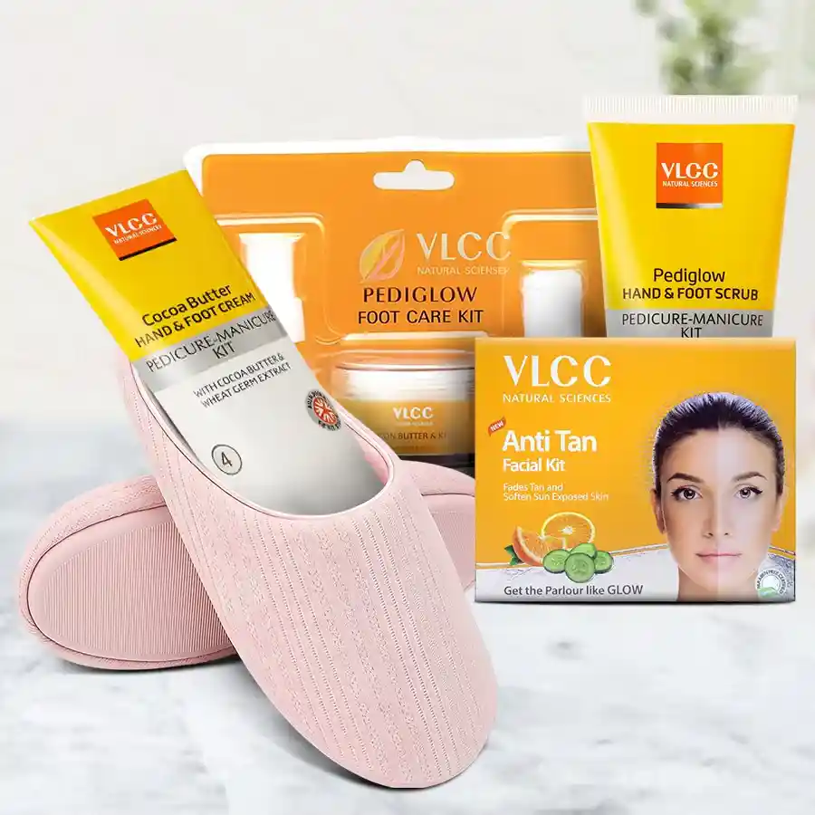 Elegant warm slippers alongside a VLCC foot care cream set, including an Orange Anti-Tan Pack, Pediglow Hand & Foot Cleanser, Scrub, and Cocoa Butter Cream, arranged beautifully for a Mother's Day gift idea.