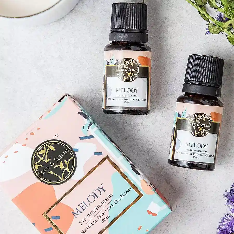Bottle of Divine Melody Essential Oil with soothing floral and herbal design, surrounded by calming elements.