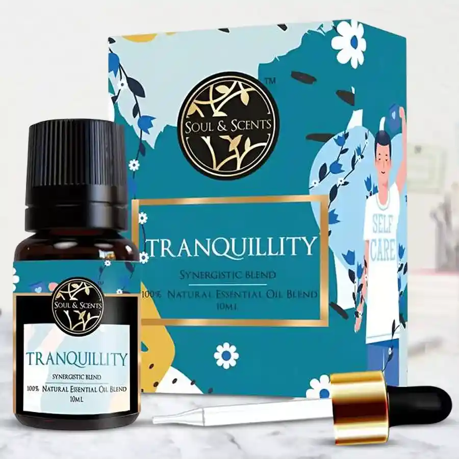 Bottle of Soothing Tranquility Essential Oil with a warm floral aroma, surrounded by calming elements like soft fabric and plants.