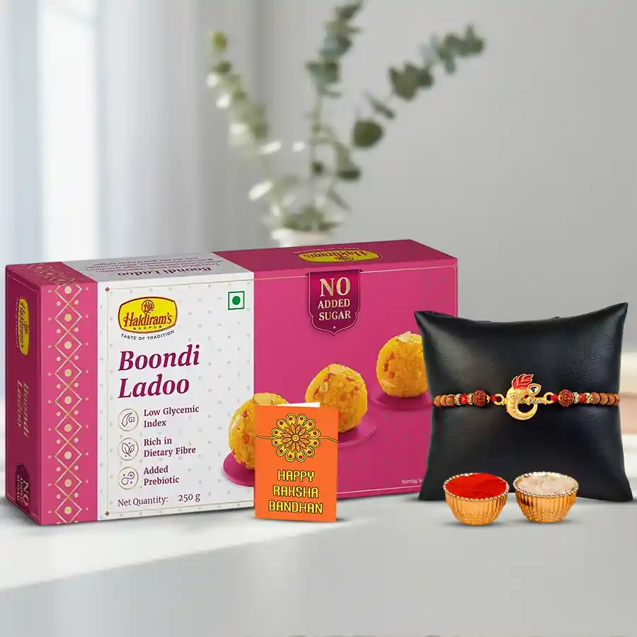 Cool Golden Ganesh Rakhi with Haldiram Boondi Ladoo and a personalized rakhi card, accompanied by Roli Tika and Chawal, set against a festive background.