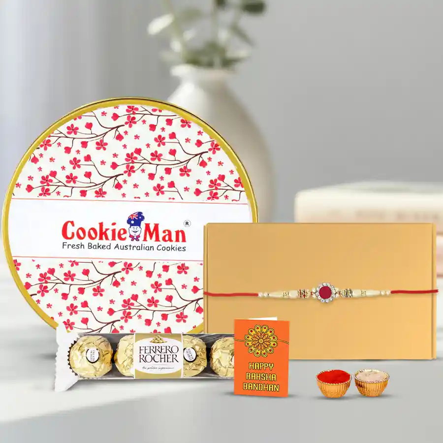 Gift box containing assorted cookies, Ferrero Rocher chocolates, a stone rakhi, and a set of roli, tika, and chawal for Raksha Bandhan celebration