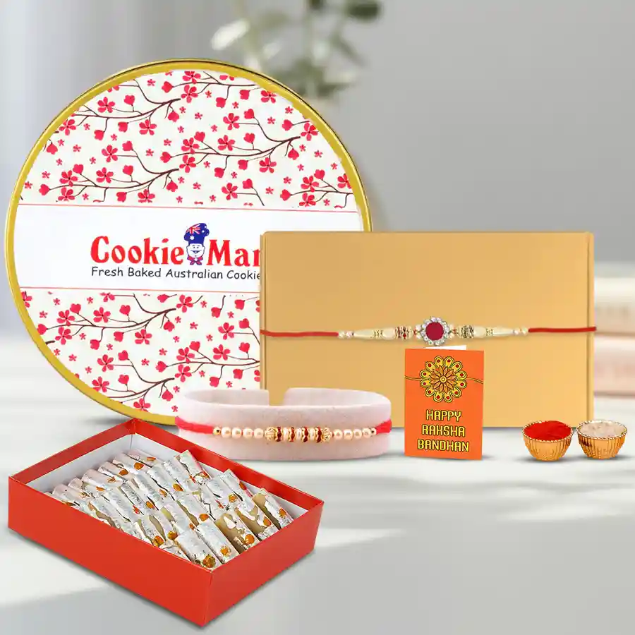 Smarty Pearl and Stone Rakhi Set with assorted cookies and Haldiram sweets on a decorative background