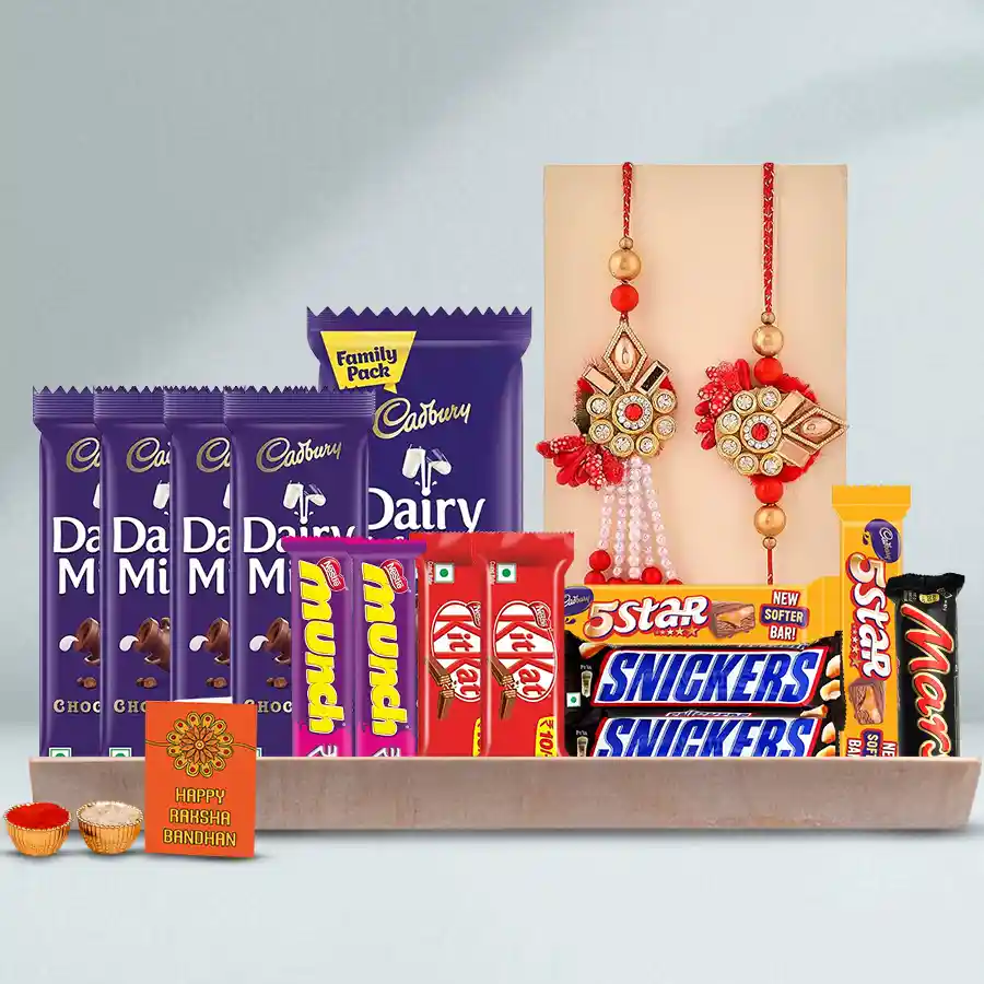 Chocolaty Emotions hamper for Bhai-Bhabhi featuring a variety of Cadbury, Nestle, and Mars chocolates, a Rakhi set, Roli, Tilak, Chawal, and a wooden tray