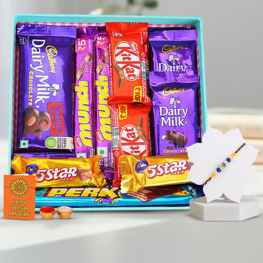 Rakhi with chocolates, card, and traditional Hindu puja items in a decorative basket.