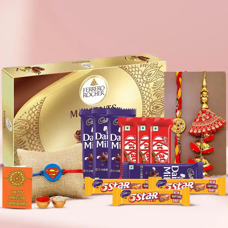 Pair of colorful rakhis surrounded by various chocolate bars and traditional items for Raksha Bandhan celebration