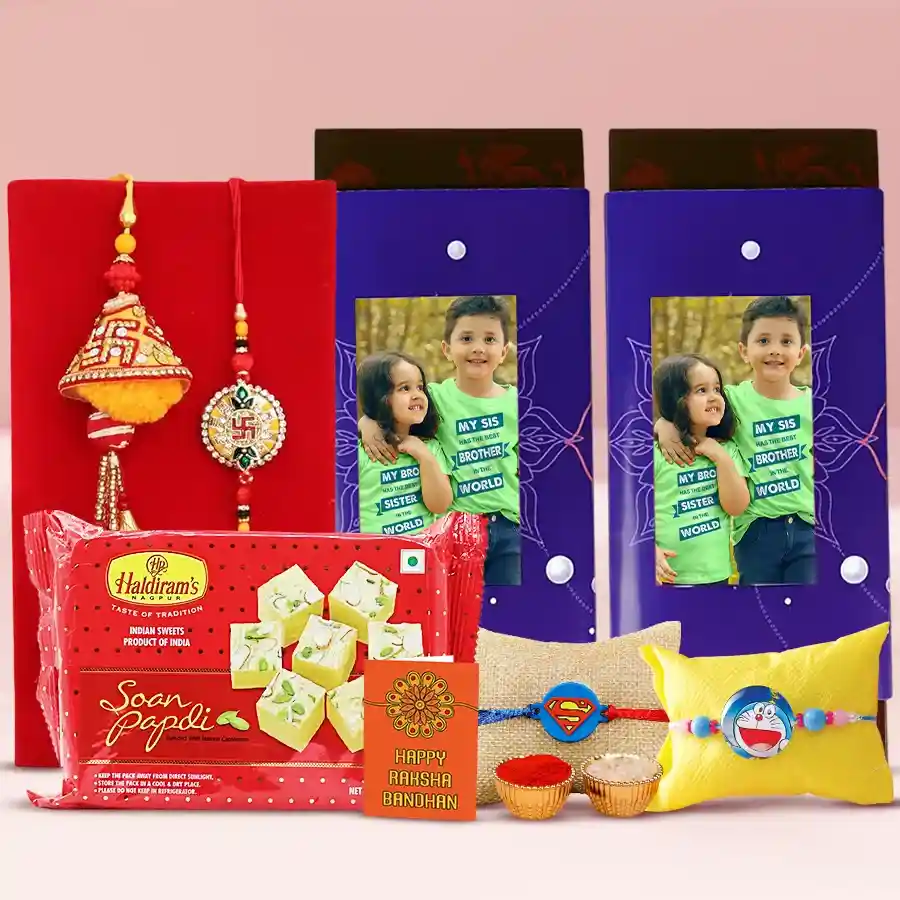 Personalized Choco Enigma gift set featuring two custom Cadbury Temptation Almond Chocolate Bars, Haldiram Soan Papdi, a Family Rakhi Set, and additional Rakhi accessories including Roli, Tilak, and Chawal.