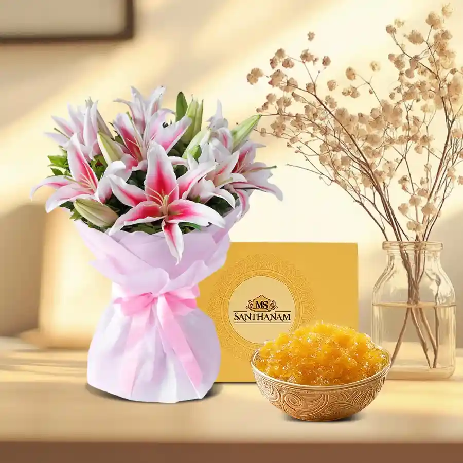 A vibrant gift combo featuring six pink lilies and a box of Damroot Halwa, beautifully arranged for a delightful presentation.