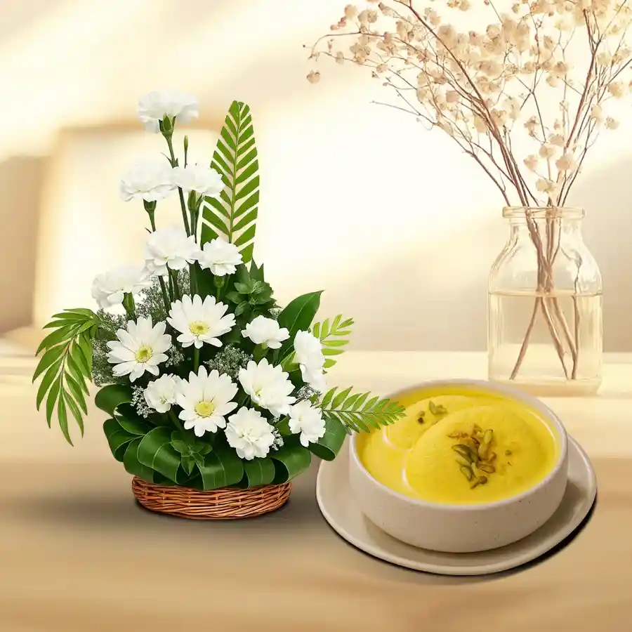 Serene gift combo featuring white carnations, gerberas, and Rosomalai treats.