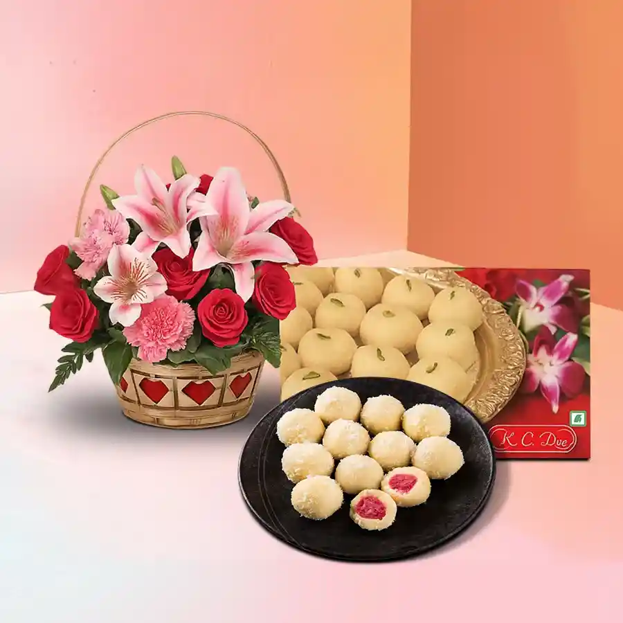 Beautiful gift combo featuring pink lilies, red carnations, pink roses, and Khir Kadam sweets. Perfect for special occasions and heartfelt moments.