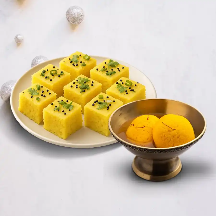 Raj Bhog and Dhokla combo featuring saffron-infused sweets and fluffy savory snacks.