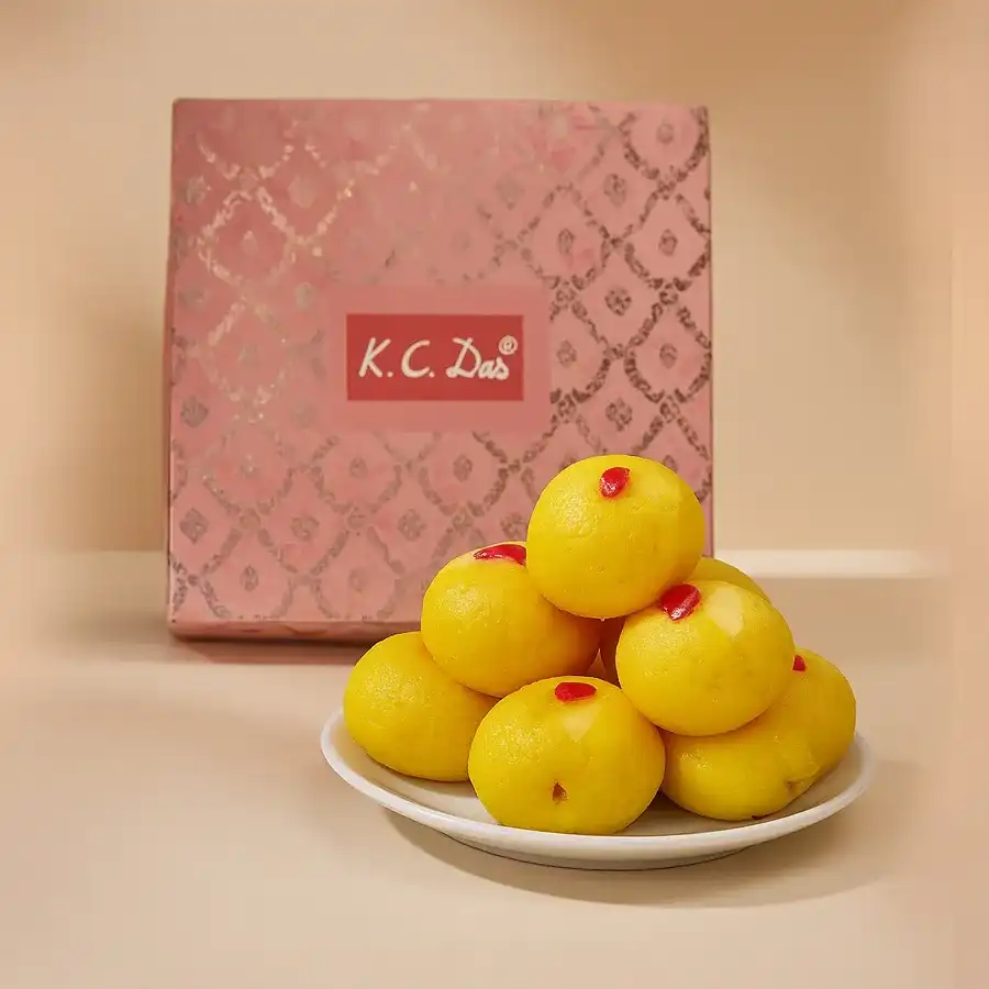 10 pieces of Raj Bhog sweets, spongy cheese dumplings soaked in fragrant syrup, showcasing Bengali dessert traditions.