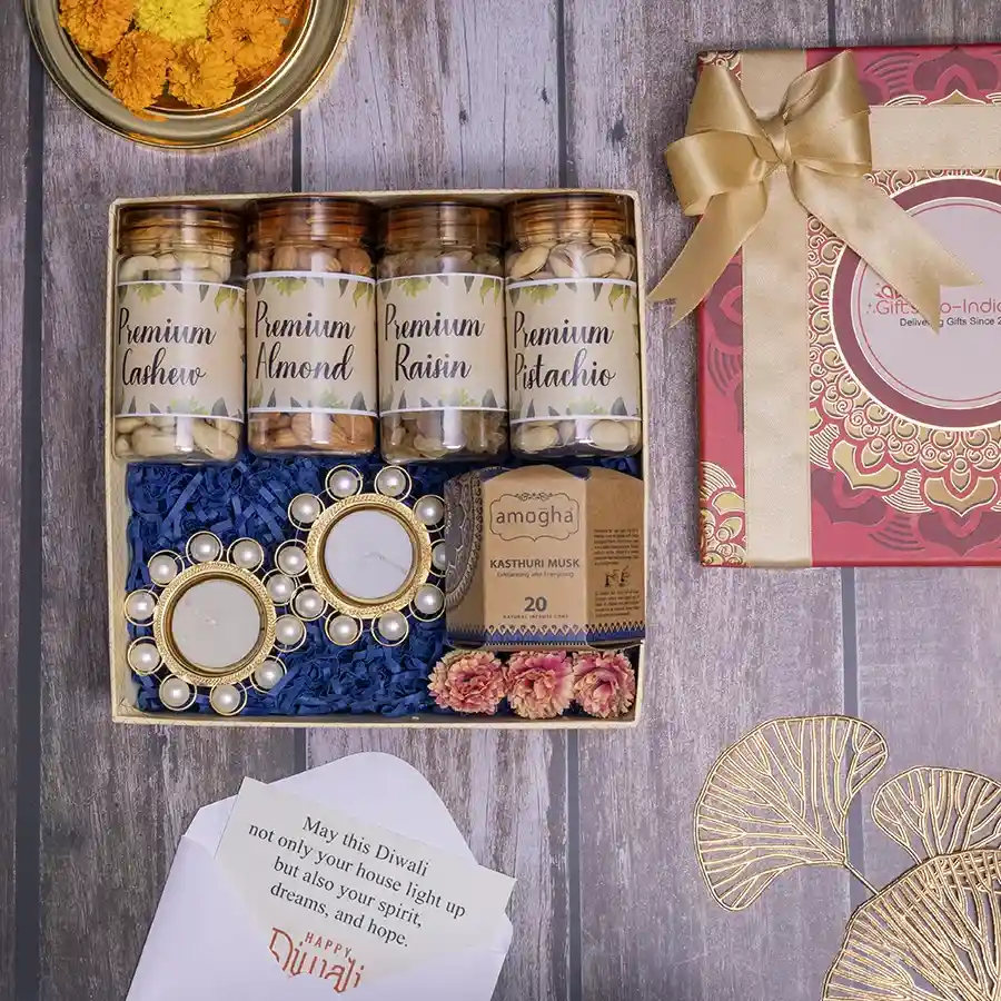 Premium Dry Fruits and Pearl Diya Set with jars of cashews, almonds, pistachios, raisins, Amogha incense cones, and elegant pearl diyas in a reusable gift box