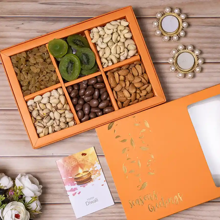 Festive Diya and Nut Delight gift hamper featuring two pearl diyas and an assortment of premium nuts and dried fruits in a reusable gift box.