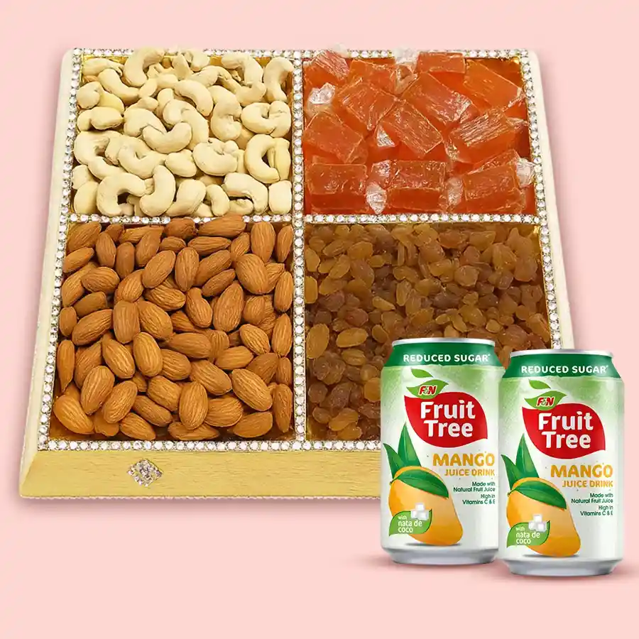 A beautifully arranged Heartfelt Dry Fruits & Juices Gift Box featuring nuts, mango toffees, and orange mango juices.