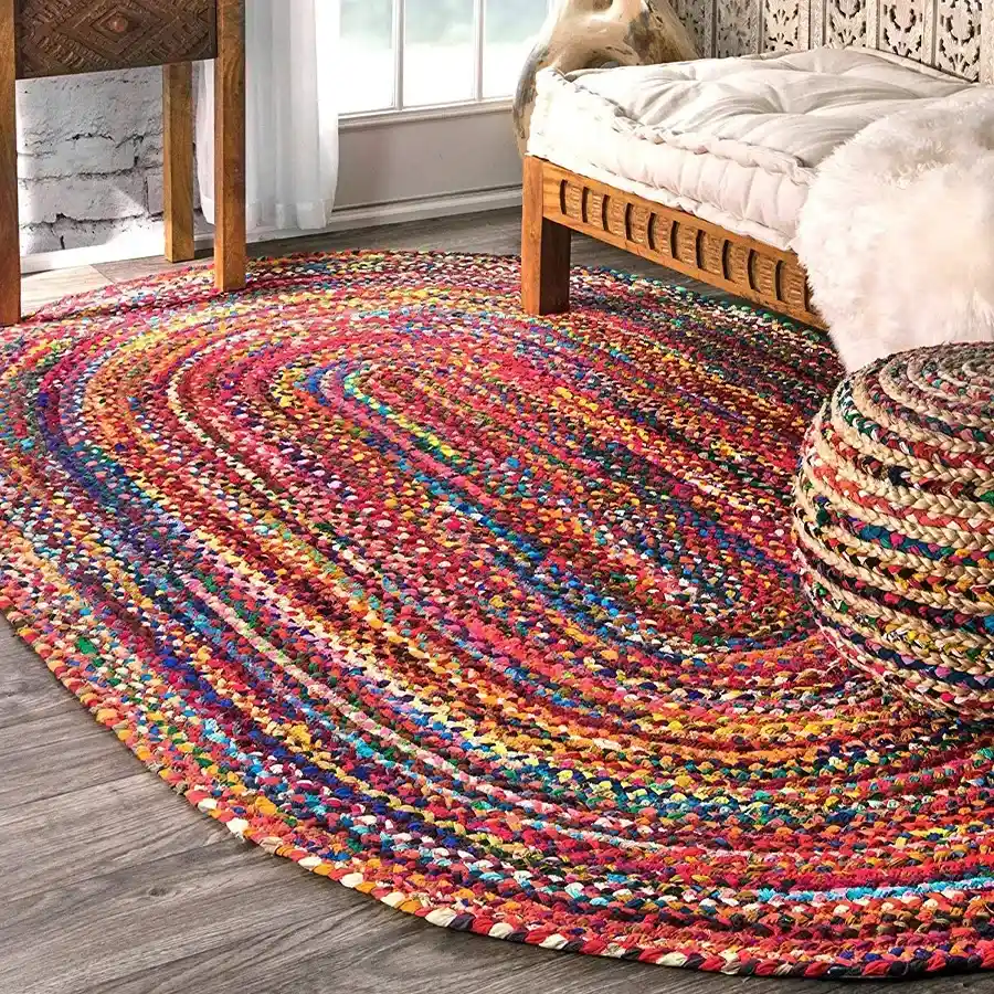 Vibrant Braided Jute Cotton Rug in multicolour, oval shape, perfect for adding warmth to your home decor.