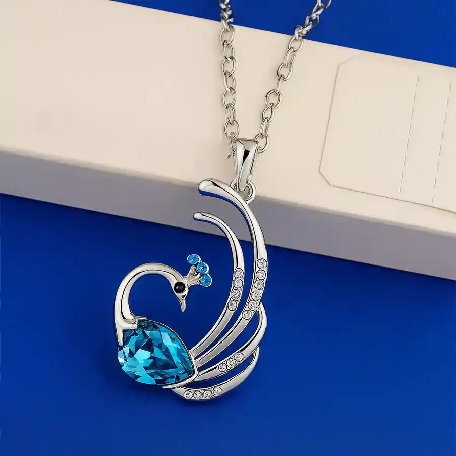 Elegant Peacock Crystal Pendant Necklace in 18k white gold plating with shimmering Austrian crystals.