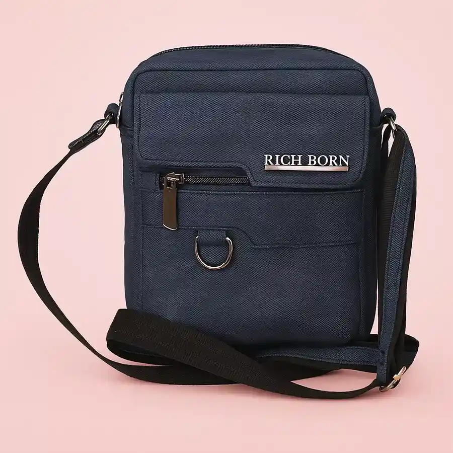 Trendy blue sling bag for men with a jeans finish and front pocket.