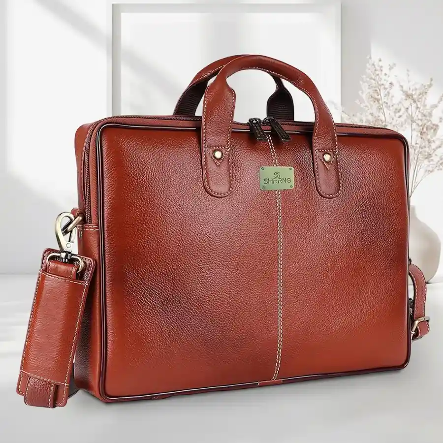 Tan leather laptop bag for men, designed for 14-inch laptops, featuring a sophisticated style and durability.