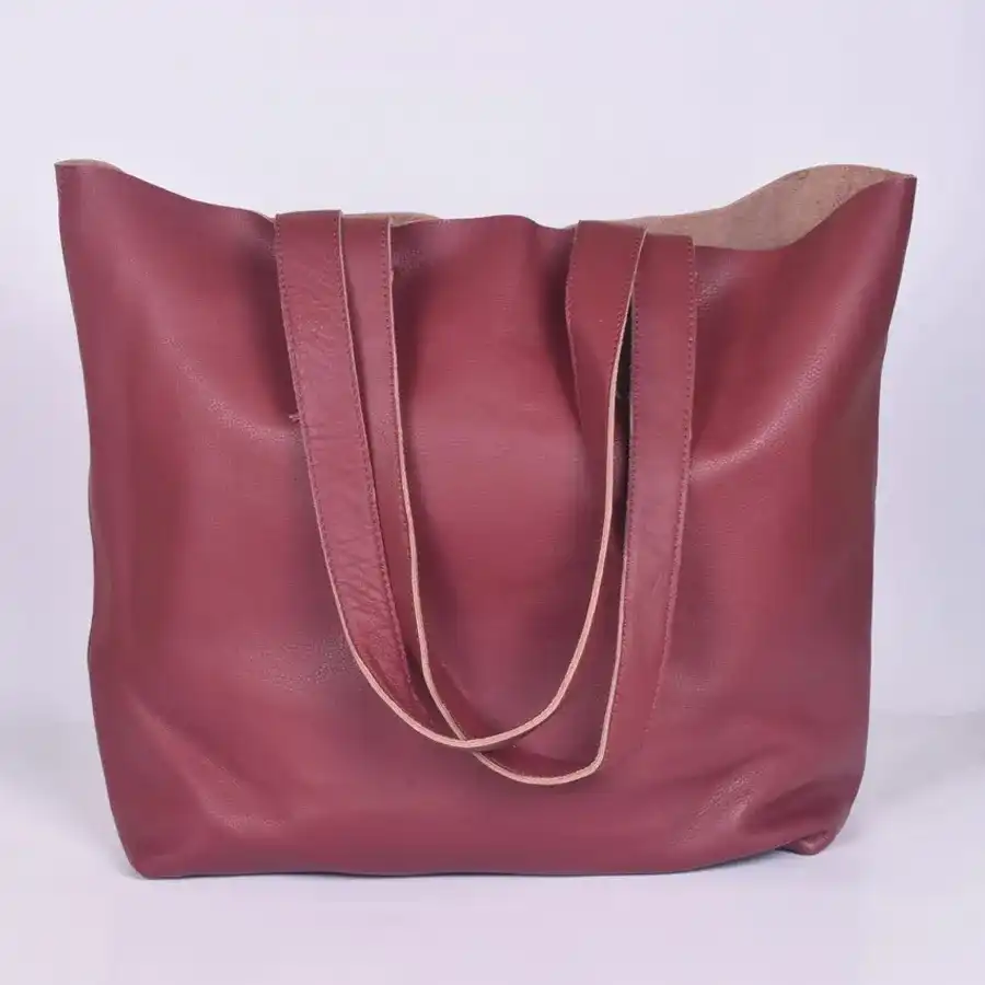 Elegant maroon leather vanity bag with front zip, featuring two chambers for organization.