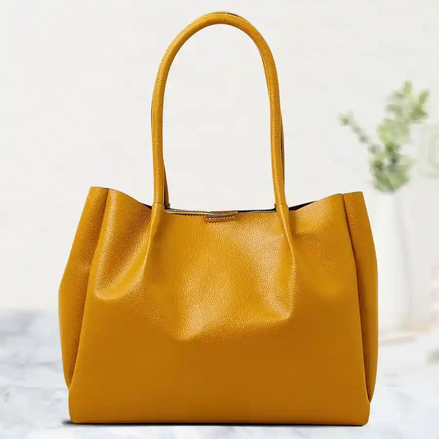 Radiant yellow faux leather shoulder bag with a stylish bottom belt design and two compartments. Perfect for everyday use.