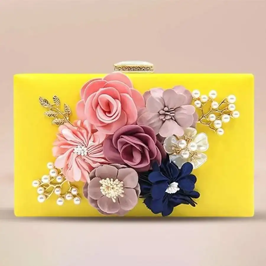 Radiant yellow floral evening clutch for women, crafted from faux leather with a floral design and stylish chain strap. Perfect for special occasions.