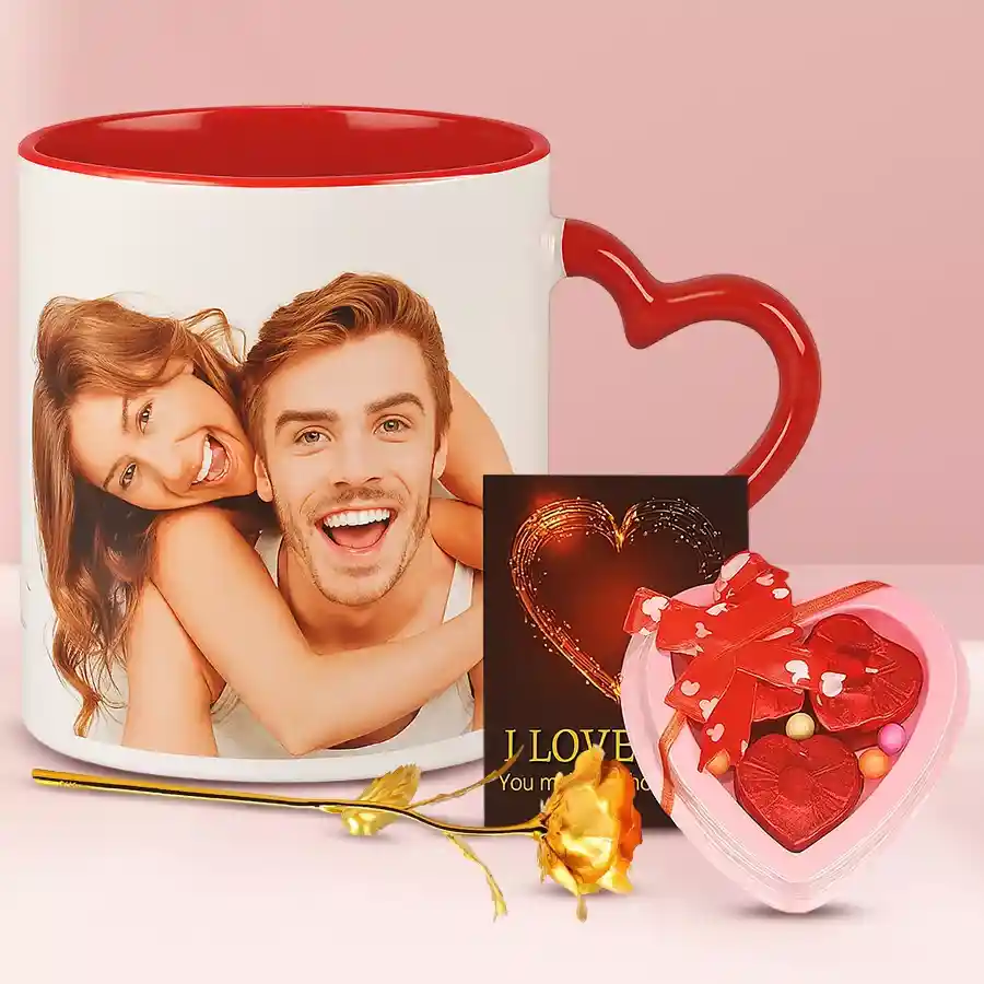 A beautiful gift set featuring six white roses, four blue orchids, and a 250-gram package of coconut barfi, all beautifully wrapped.